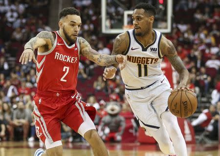 Mar 28, 2019; Houston, TX, USA; Denver Nuggets guard Monte Morris (11) dribbles the ball as Houston Rockets guard Chris Chiozza (2) defends during the fourth quarter at Toyota Center. Mandatory Credit: Troy Taormina-USA TODAY Sports