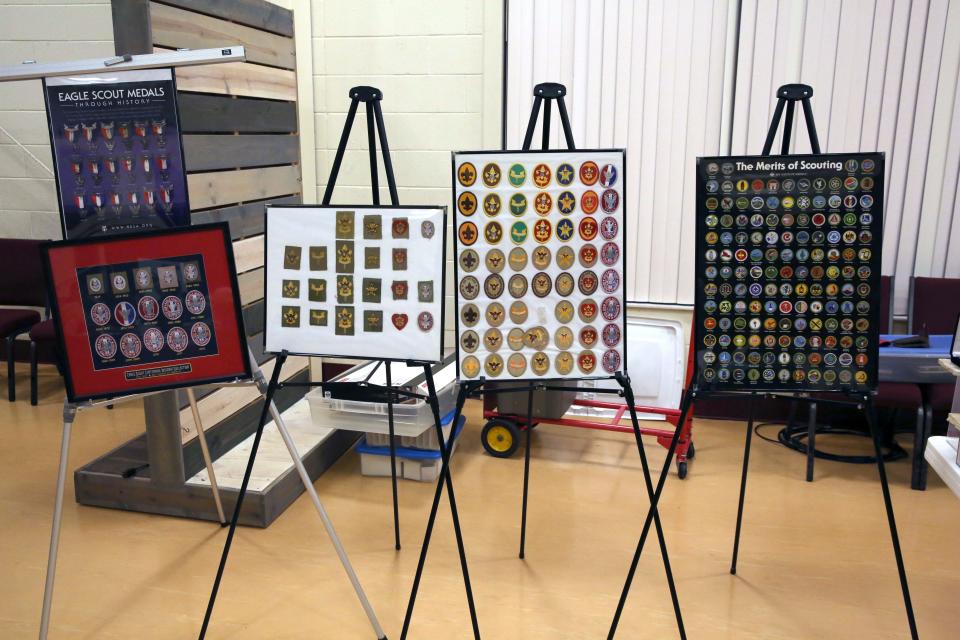 A display of merit badges that can be earned, along with ranks badges and Eagle Scout medals and badges that have been used by the Boy Scouts of America over the years.