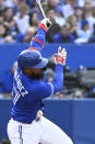 Toronto Blue Jays' Teoscar Hernandez is hit by a foul tip during the second inning of the team's baseball game against the Cincinnati Reds o Friday, May 20, 2022, in Toronto. (Jon Blacker/The Canadian Press via AP)