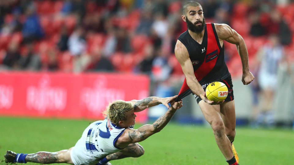 Essendon's Adam Saad is pictured breaking a tackle during the 2020 AFL season.