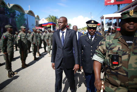 Haitian President Jovenel Moise (C) and acting Chief of the army's high command Jodel Lesage inspect the troops before a parade of the Haitian Armed Forces (FAD'H) in the streets of Cap-Haitien, Haiti, November 18, 2017. REUTERS/Andres Martinez Casares