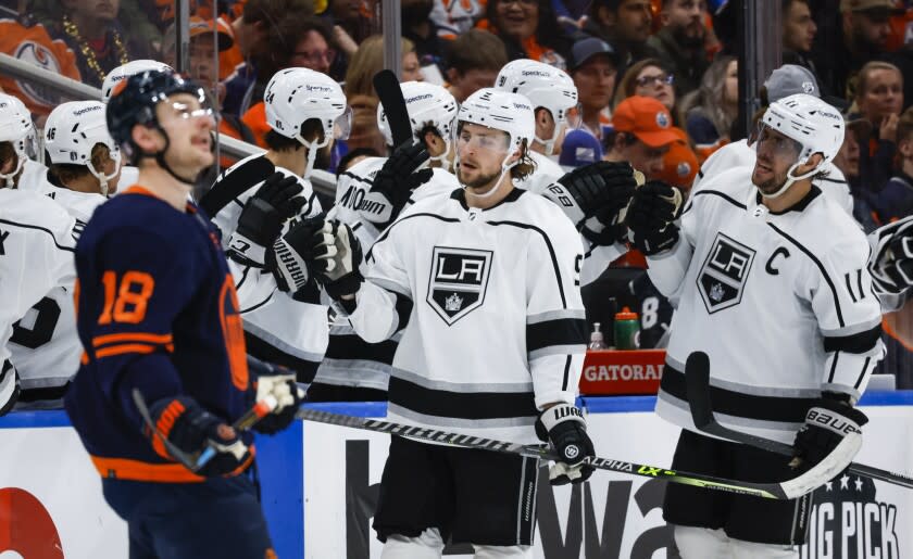 Los Angeles Kings Adrian Kempe, center, celebrates his goal with teammates as Edmonton Oilers left wing Zach Hyman looks away during the second period of Game 5 of an NHL hockey Stanley Cup first-round playoff series, Tuesday, May 10, 2022 in Edmonton, Alberta. (Jeff McIntosh/The Canadian Press via AP)