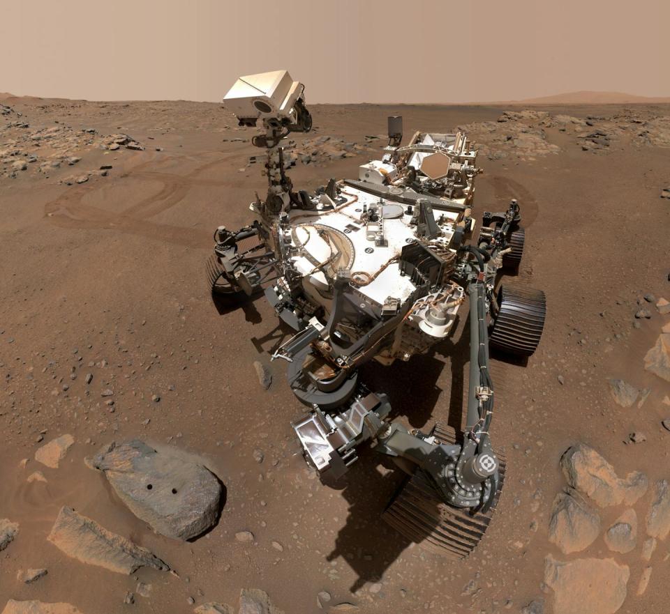 The Endurance rover, dusty and dirty, parked in a patch of Martian soil.