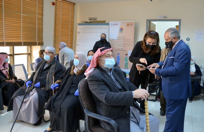 Jordanians wait to receive the COVID-19 vaccine, at a medical center in Amman