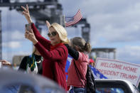 Supporters of President Donald Trump wave as the motorcade passes ny on the road to Mar-a-Lago, Trump's Palm Beach estate, on Wednesday, Jan. 20, 2021, in West Palm Beach, Fla. (AP Photo/Lynne Sladky)