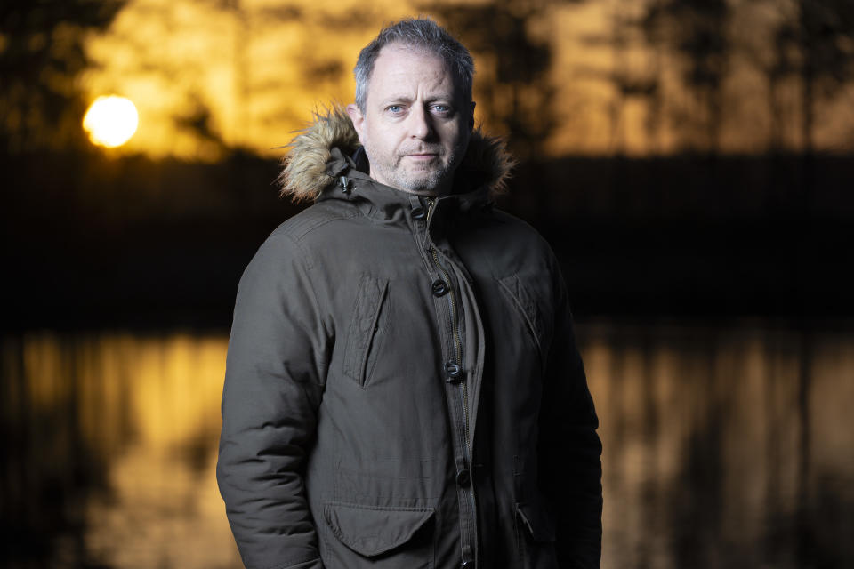 Flash portrait with golden sunrise and lake backdrop