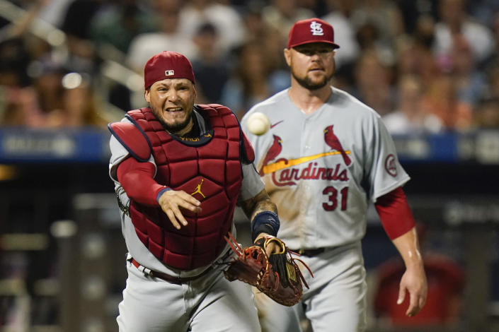 St. Louis Cardinals starting pitcher Jon Lester, right, watches as catcher Yadier Molina throws out New York Mets' Jonathan Villar at first base during the fifth inning of a baseball game Wednesday, Sept. 15, 2021, in New York. (AP Photo/Frank Franklin II)