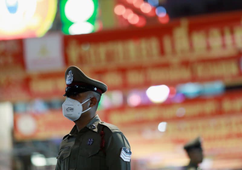 A police officer wears a mask during the celebration of the Chinese Lunar New Year in Chinatown in Bangkok, Thailand