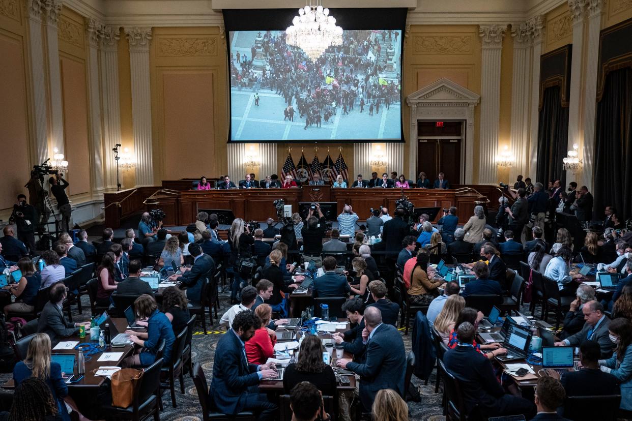 The House committee investigating the riot at the Capitol on Jan. 6, 2021, shows video of the attack during a hearing June 13 in Washington.