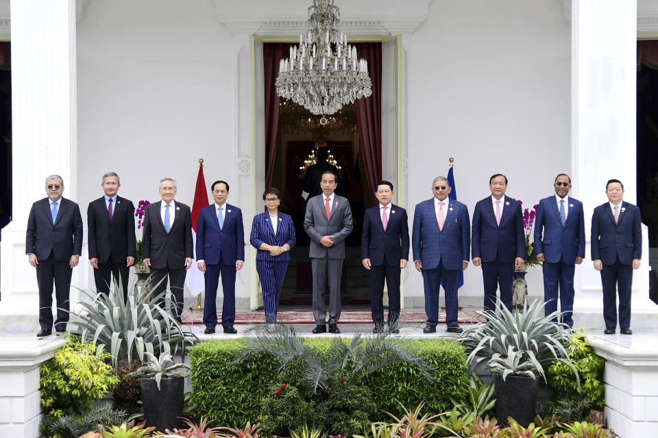 In this photo released by the Indonesian Presidential Palace, President Joko Widodo, center, pose for a group photo with Southeast Asian Foreign Ministers, from left to right; Philippines Foreign Secretary Enrique Manalo, Singapore's Foreign Minister Vivian Balakrishnan, Thailand's Foreign Minister Don Pramudwinai, Vietnam's Foreign Minister Bui Thanh Son, Indonesian Foreign Minister Retno Marsudi, Widodo, Laotian Foreign Minister Saleumxay Kommasith, Brunei's Second Minister of Foreign Affair Erywan Yusof, Cambodia's Foreign Minister Prak Sokhonn, Malaysia's Foreign Minister Zambry Abdul Kadir, and ASEAN Secretary General Kao Kim Hourn during their meeting ahead of the Association of Southeast Asian Nations (ASEAN) Coordinating Council Meeting, at Merdeka Palace in Jakarta, Indonesia, Friday, Feb. 3, 2023. Southeast Asian foreign ministers are meeting in Indonesia's capital Friday for talks bound to be dominated by the deteriorating situation in Myanmar despite an agenda focused on food and energy security and cooperation in finance and health. (Indonesian Presidential Palace via AP)