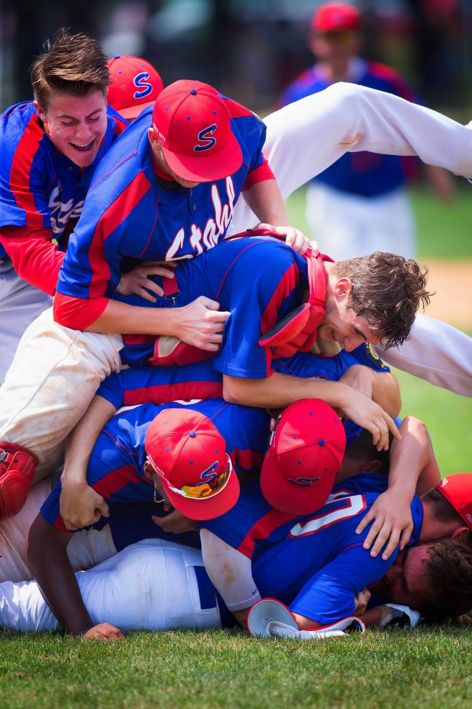 Stahl Post 30 teammates dog pile each other as they celebrate a recent state American Legion championship at Wilson Field.