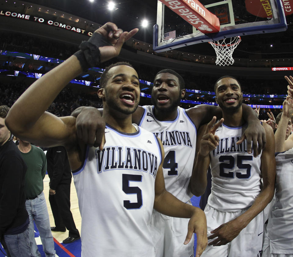 Villanova’s Phil Booth, left, celebrates the win with Eric Paschall, center, and Mikal Bridges after the second half of an NCAA college basketball game against Georgetown, Saturday, March 3, 2018, in Philadelphia. Villanova won 97-73. (AP Photo/Chris Szagola)