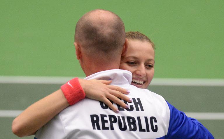 Petra Kvitova of the Czech Republic celebrates with Czech Fed Cup team captain Petr Pala after defeating Kristina Mladenovic of France in the semi-final in Ostrava on April 18, 2015