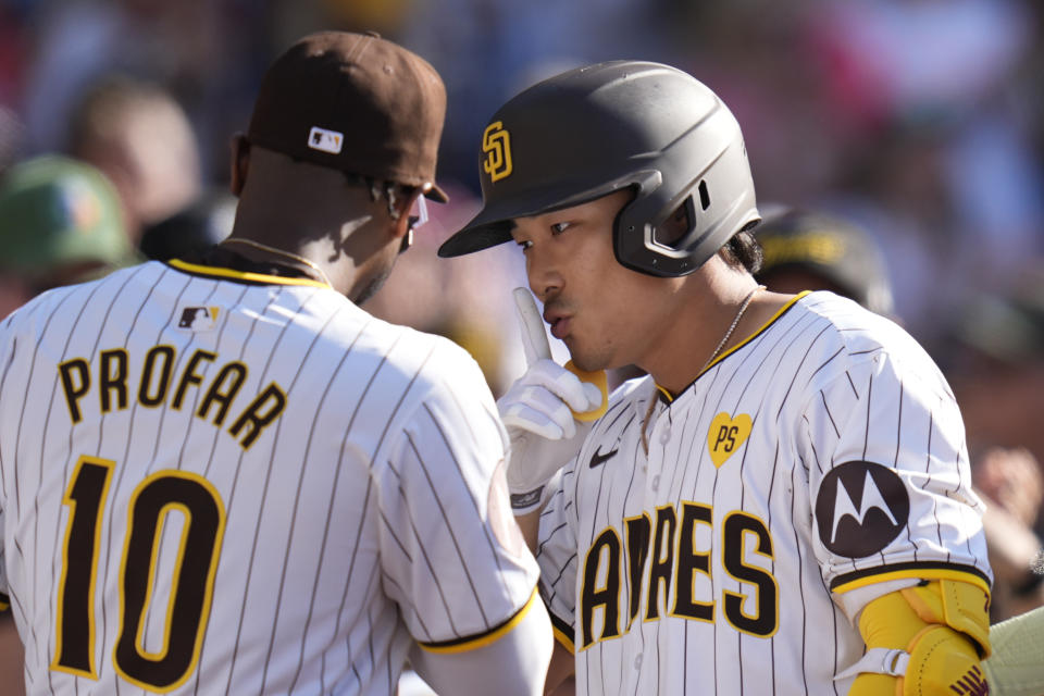 San Diego Padres' Ha-Seong Kim, right, celebrates with teammate Jurickson Profar after hitting a home run during the fourth inning of a baseball game against the Milwaukee Brewers, Saturday, June 22, 2024, in San Diego. (AP Photo/Gregory Bull)