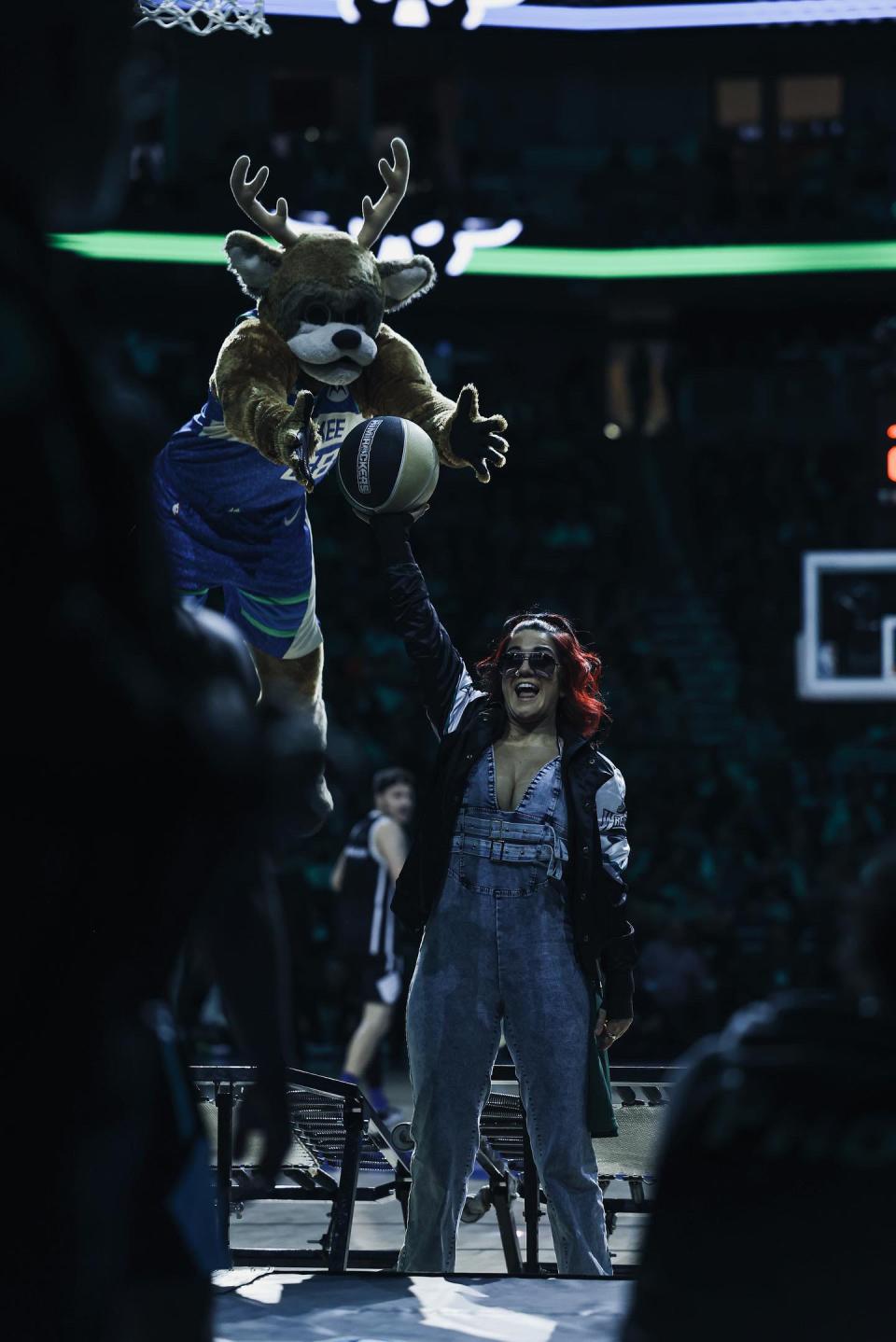 WWE superstar Bayley provides the assist to Bango during a break in the action of the Milwaukee Bucks game against the Brooklyn Nets on Thursday, March 21, 2024. She'll appear at "SmackDown" on Friday in Milwaukee.