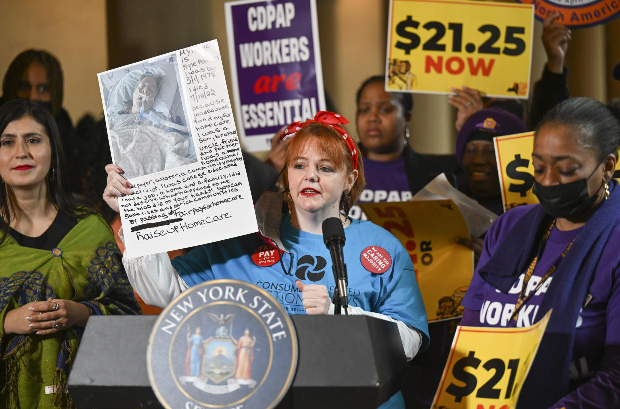 Health aid Tara Murphy stands with protesters urging lawmakers to raise New York's minimum wage during a rally at the state Capitol, Monday, March 13, 2023, in Albany, N.Y. (AP Photo/Hans Pennink)