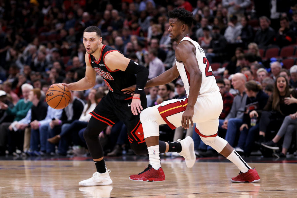 CHICAGO, ILLINOIS - NOVEMBER 22: Zach LaVine #8 of the Chicago Bulls dribbles the ball while being guarded by Jimmy Butler #22 of the Miami Heat in the fourth quarter at the United Center on November 22, 2019 in Chicago, Illinois. NOTE TO USER: User expressly acknowledges and agrees that, by downloading and or using this photograph, User is consenting to the terms and conditions of the Getty Images License Agreement. (Photo by Dylan Buell/Getty Images)