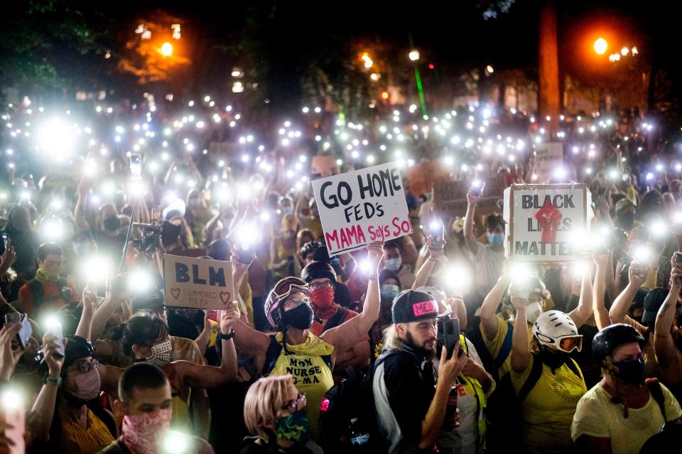 Hundreds of Black Lives Matter protesters hold their lighted phones aloft in Portland, Ore., on July 20, 2020. 