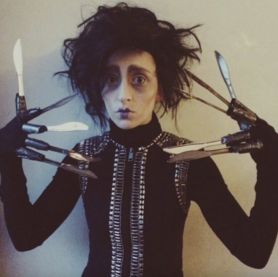 Someone dressed as Edward Scissorhands but with kitchen knives taped to their fingers