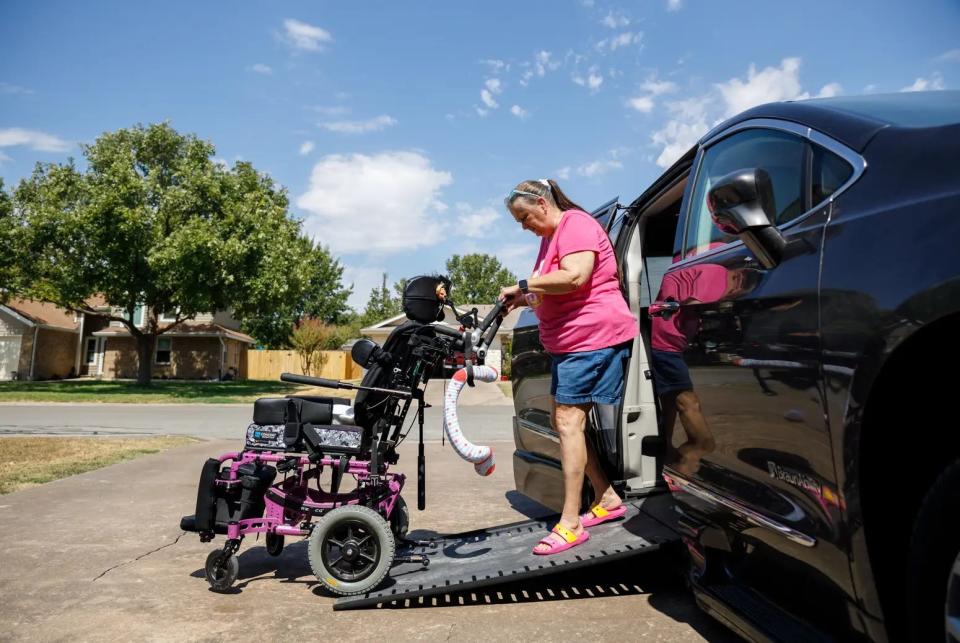 Laurie Sharp demonstrates the wheelchair ramp on her converted van for wheelchair access, a process which took several weeks and cost $30,000.