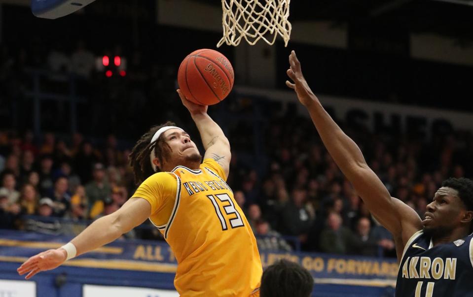 Kent State's Jalen Sullinger attempts to dunk as Akron's Sammy Hunter defends during their game at the MAC Center in Kent on Friday. The flashes beat the Zips 89-84 in overtime.