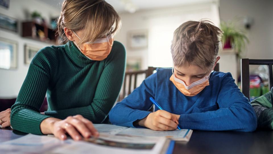 Mother and little boy wearing face masks.