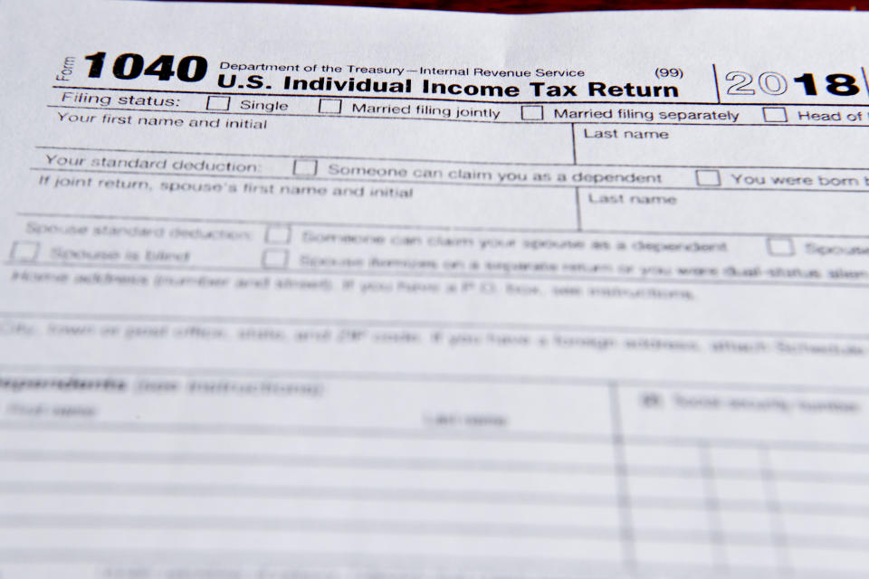 This photo made on Wednesday, Feb. 13, 2019, in Zelienople, Pa., shows 1040 tax forms printed from the Internal Revenue Service web page that are used for 2018 U.S. federal tax returns. (AP Photo/Keith Srakocic)