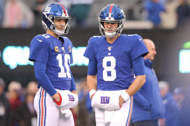 New York Giants starting quarterback Eli Manning rolls out to the