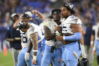 Tennessee Titans defensive end DeMarcus Walker, right, talks with quarterback Malik Willis during the second half of a preseason NFL football game against the Baltimore Ravens, Thursday, Aug. 11, 2022, in Baltimore. (AP Photo/Gail Burton)