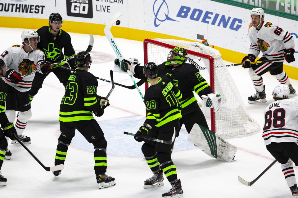 Dallas Stars goaltender Jake Oettinger (29) attempts to grab the puck out of the air during the first period of an NHL hockey game against the Chicago Blackhawks, Sunday, Feb. 7, 2021, in Dallas. (AP Photo/Sam Hodde)