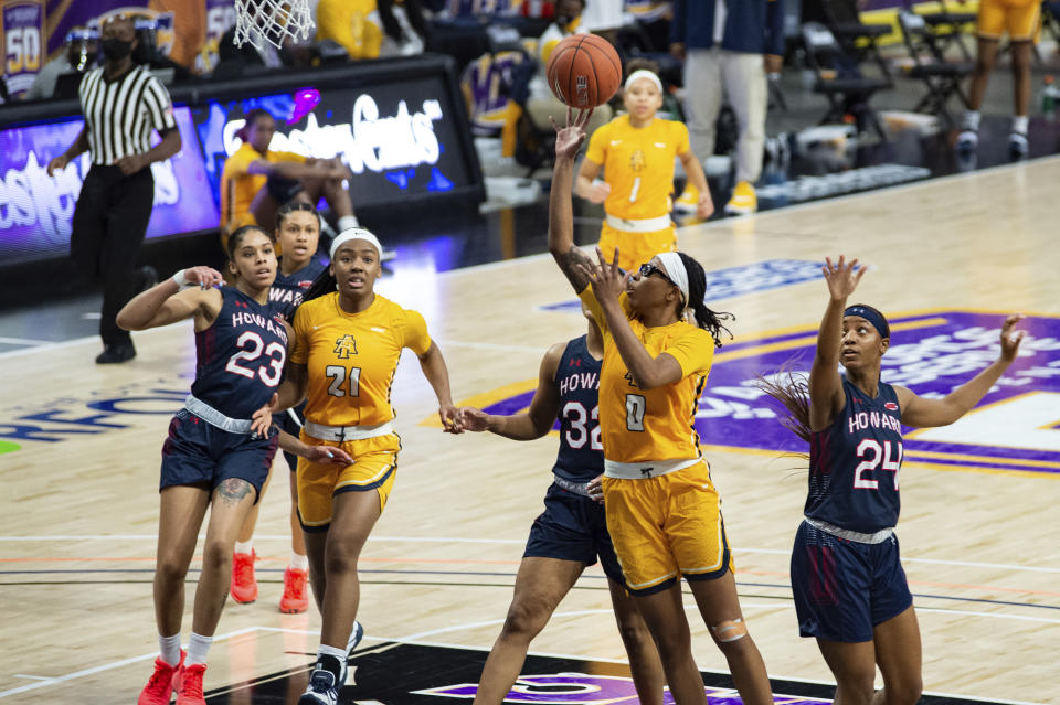 North Carolina A&T's Jasmen Walton (0) takes a shot during the first half of an NCAA college basketball game in the Mid-Eastern Athletic Conference championship Saturday, March 13, 2021, in Norfolk, Va. (AP Photo/Mike Caudill)