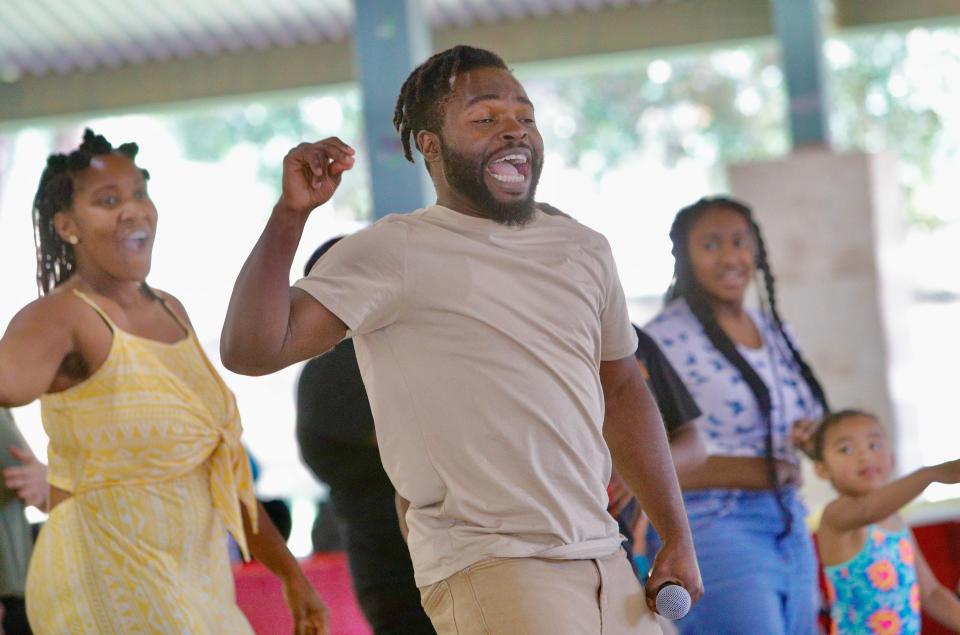 Damilola Afolabi, originally from Nigeria, leads a freedom dance at the Juneteenth celebration in Redding on Saturday, June 18, 2022, after telling the story of a man who was captured after fleeing from a plantation.