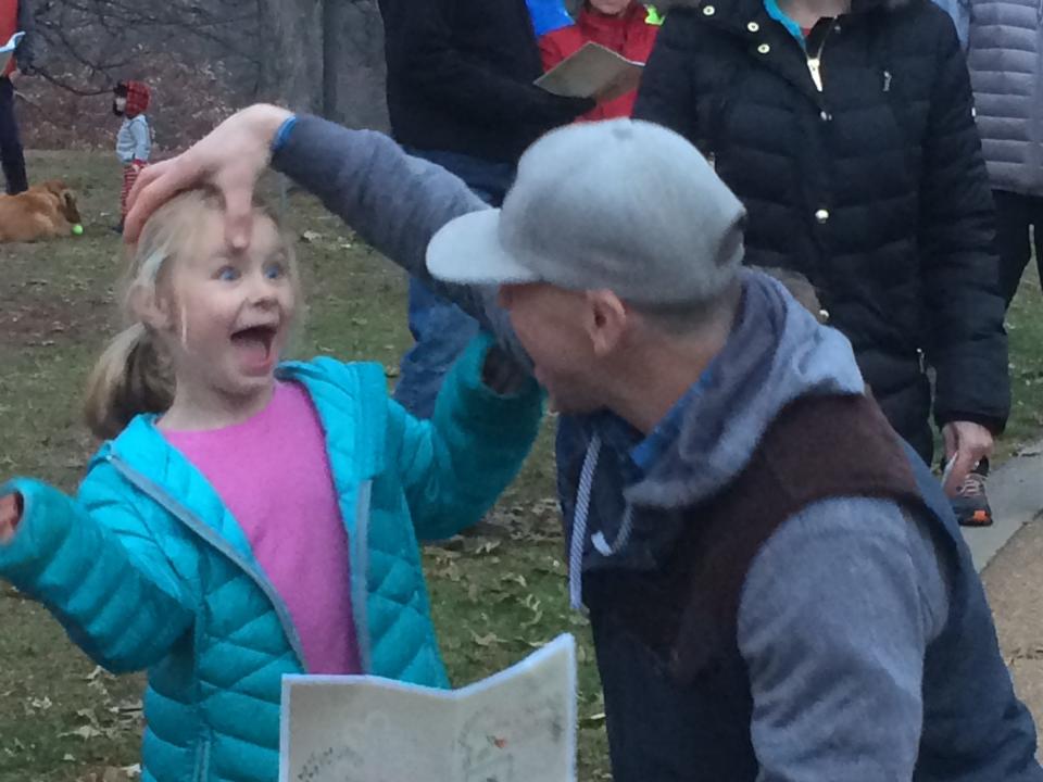 Victor Yanz has a playful moment with his daughter, Annika, 6, while singing "Frosty the Snowman" at the 38th annual Caroling at the Carillon in Washington Park in Springfield Sunday. The event featured the Trinity Wind Ensemble and carillonist Carlo van Ulft. [Photo by Steven Spearie]