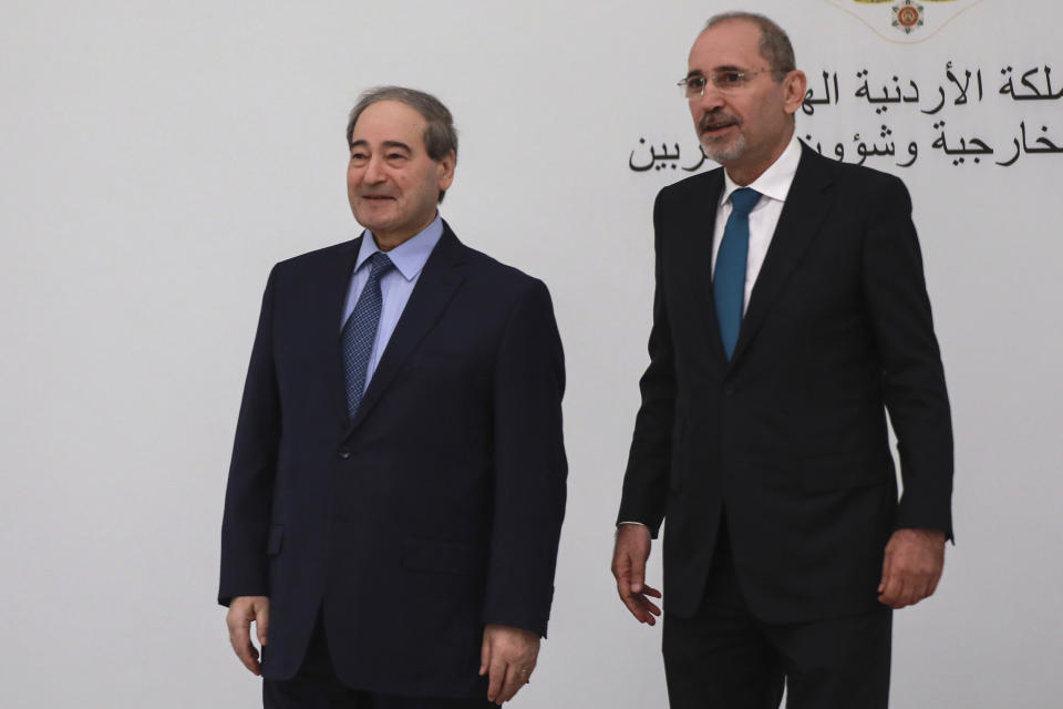 Jordan's Foreign Minister Ayman Safadi, right, arrives with his Syrian counterpart Faisal Mekdad to attend a regional consultative meeting held in Amman, Jordan, Monday, May 1, 2023. Regional leaders are meeting in Jordan to discuss Syria's return to the Arab fold and a Jordanian proposal to reach a "political solution" to the Syrian conflict. The talks, attended by the top diplomats of Jordan, Syria, Saudi Arabia, Iraq and Egypt, kicked off Monday with a meeting between Jordanian Foreign Minister Ayman Safadi and Syrian Foreign Minister Faisal Mekdad. (AP Photo/Raad Adayleh)