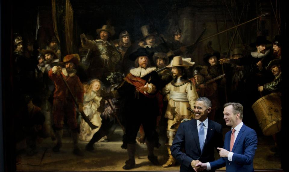 U.S. President Barack Obama, left, and museum director Wim Pijbes pose in front of Dutch master Rembrandt's The Night Watch painting during a visit to the Rijksmuseum in Amsterdam, Netherlands, Monday, March 24, 2014. Obama will attend the two-day Nuclear Security Summit in The Hague. (AP Photo/Jerry Lampen, Pool)