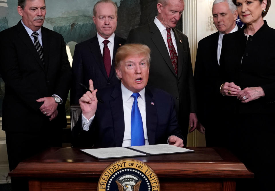 U.S. President Donald Trump, surrounded by business leaders and administration officials, prepares to sign a memorandum on intellectual property tariffs on high-tech goods from China, at the White House in Washington, U.S. March 22, 2018.&nbsp; (Photo: Jonathan Ernst / Reuters)