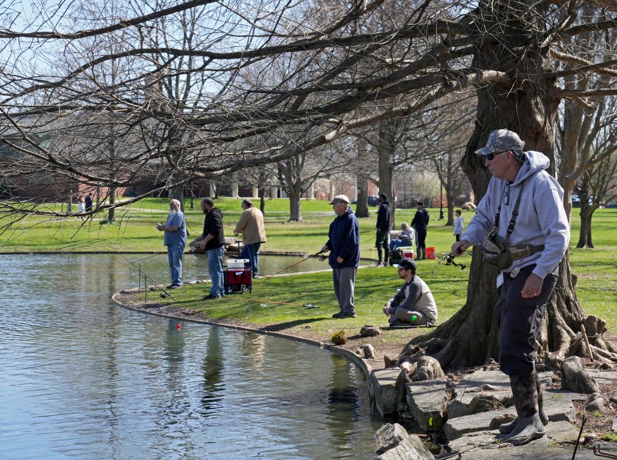 People fish from the pond in Schiller Park in April after the Ohio Department of Natural Resources stocked it with hundreds of rainbow trout.
