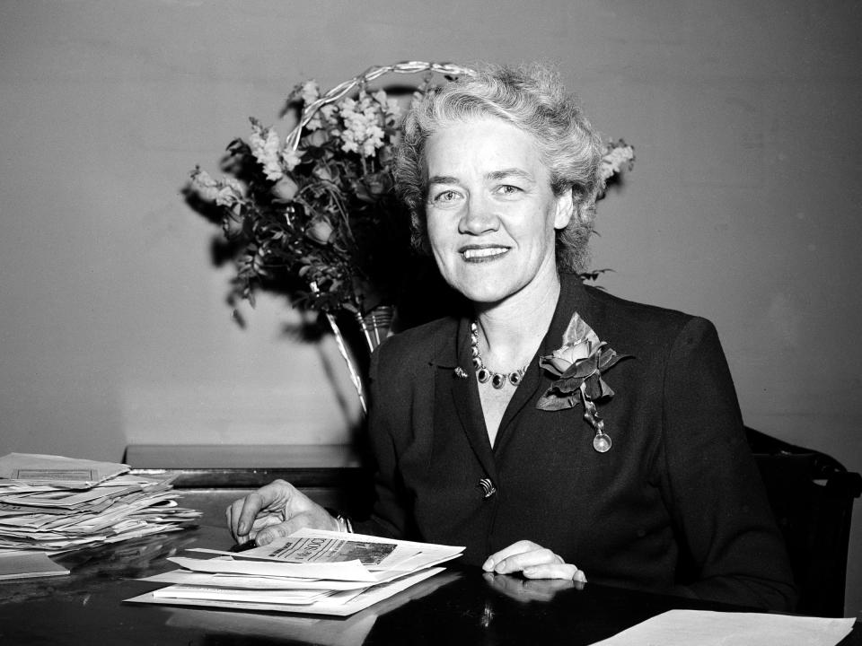Margaret Chase Smith sits at a desk in a black and white photo