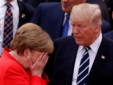 FILE PHOTO: German Chancellor Angela Merkel reacts next to U.S. President Donald Trump during the G20 leaders summit in Hamburg, Germany July 7, 2017. REUTERS/Philippe Wojazer/File Photo