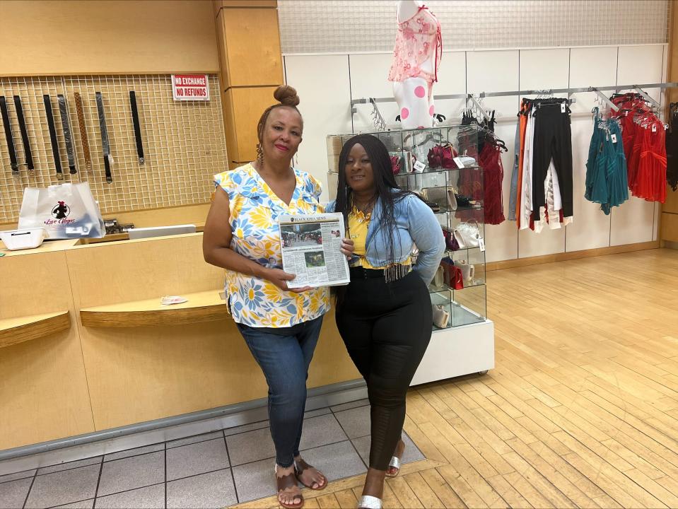 Dana James, publisher of Black Iowa News, holding the first print edition of the quarterly paper, stands with Love Temah at Love Vegas Lingerie Boutique. The boutique is one of many locations throughout Iowa where readers can pick up a free copy of the paper.