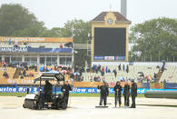 Ground staff attempt to make the wicket playable during the ICC Champions Trophy Final at Edgbaston, Birmingham.