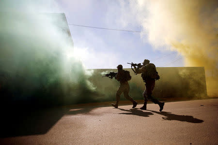 U.S. Marine and an Israeli soldier practice urban combat during Juniper Cobra, a U.S.-Israeli joint air defence exercise, in Zeelim, southern Israel, March 12, 2018. REUTERS/Amir Cohen