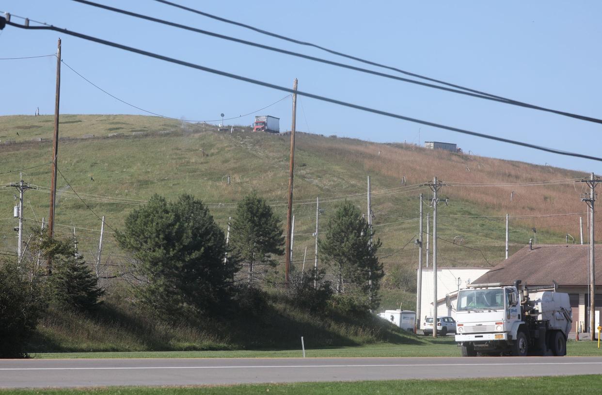 Tractor trailers can be seen coming and going, driving along the ridge of Seneca Meadows Inc. landfill that borders NY 414.
(Credit: Tina MacIntyre-Yee /Rochester Democrat and Chronicle)