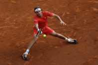 Stefanos Tsitsipas, of Greece, returns the ball against Dusan Lajovic, of Serbia, during a semi final open tennis tournament in Barcelona, Spain, Saturday, April 20, 2024. (AP Photo/Joan Monfort)