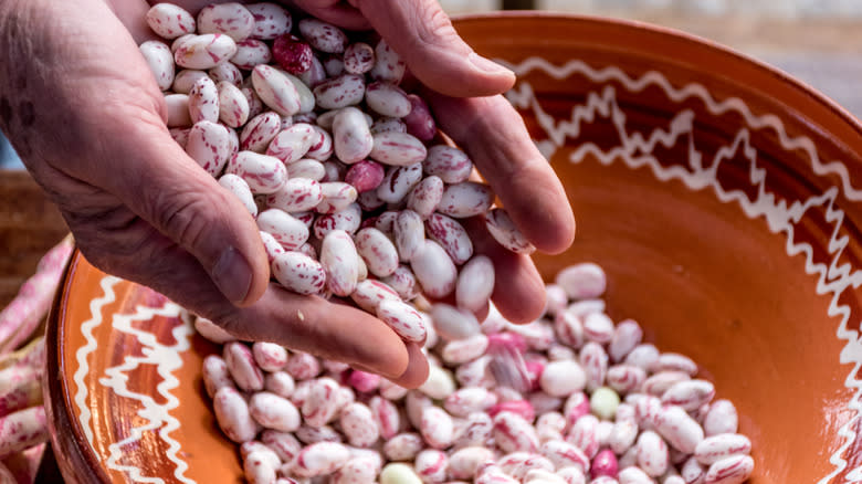 woman holding shelled beans