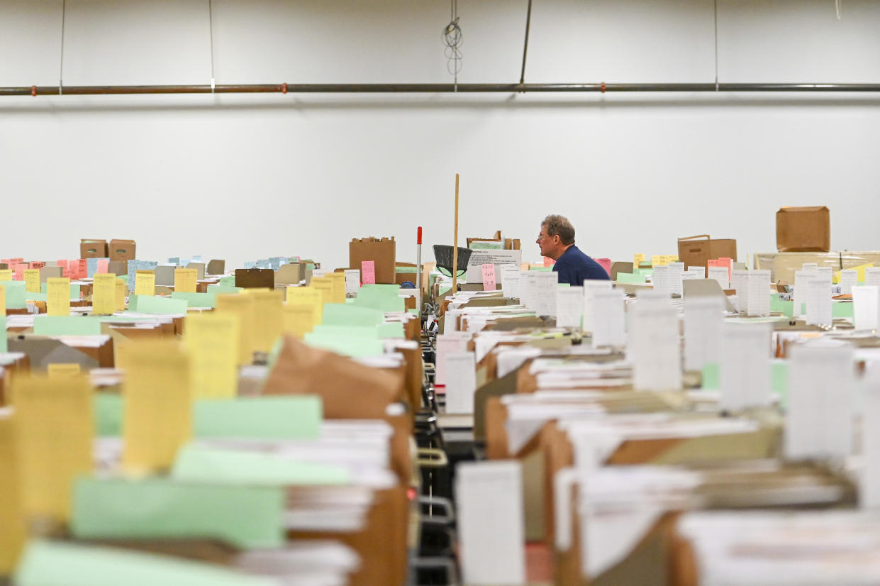 OGDEN, UTAH - MARCH 31: A custodian walks through tax documents in the staging warehouse at an Internal Revenue Service facility on March 31, 2022 in Ogden, Utah. (Photo by Alex Goodlett for The Washington Post via Getty Images)