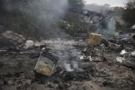 A gas cooker is seen in the charred debris from fires overnight that destroyed makeshift shelters and tents in the "Jungle" on the third day of their evacuation and transfer to reception centers in France, as part of the dismantlement of the camp in Calais, France, October 26, 2016. REUTERS/Neil Hall