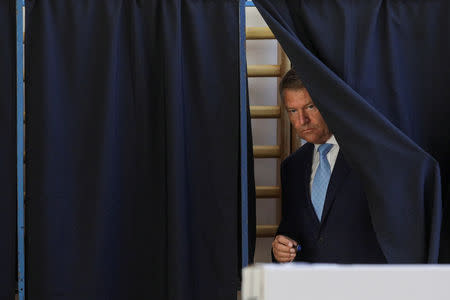 Romanian President Klaus Iohannis leaves a polling booth to cast his vote during the European Parliament Elections in Bucharest, Romania, May 26, 2019. Inquam Photos/Octav Ganea via REUTERS