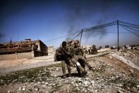 Members of Iraq's elite Rapid Response Division carry a wounded comrade during an offensive to retake the western half of Mosul from Islamic State group fighters on February 25, 2017