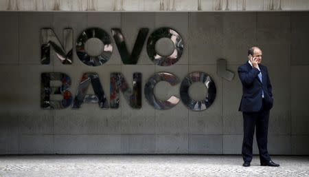 A man uses a mobilephone outside Novo Banco's headquarters in Lisbon, Portugal September 15, 2015. REUTERS/Rafael Marchante